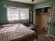 Bright bedroom featuring a double bed, armchair, and ample closet space at 1701 N Hastings St, Orlando, FL 32808