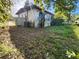 White block house with overgrown landscaping and AC unit at 1701 N Hastings St, Orlando, FL 32808