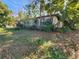 White house with overgrown landscaping at 1701 N Hastings St, Orlando, FL 32808