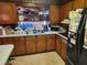 Kitchen with wood cabinets, double sink and appliances at 1701 N Hastings St, Orlando, FL 32808