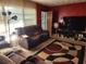 Living room with brown couches and a large TV at 1701 N Hastings St, Orlando, FL 32808