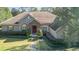 One-story house with a tile roof, landscaping, and a walkway at 25628 Hawks Run Ln, Sorrento, FL 32776