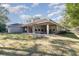 House with a large backyard and covered patio at 25628 Hawks Run Ln, Sorrento, FL 32776
