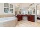 Elegant bathroom with a large soaking tub and dual vanity at 25628 Hawks Run Ln, Sorrento, FL 32776