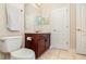 Clean bathroom with wood vanity and updated fixtures at 25628 Hawks Run Ln, Sorrento, FL 32776
