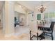 Elegant dining area with a charming wooden table, and view into living room at 25628 Hawks Run Ln, Sorrento, FL 32776
