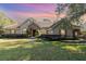 One-story house with stone accents, red door, and nicely landscaped lawn at 25628 Hawks Run Ln, Sorrento, FL 32776