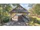 Community entrance with covered bridge and water features at 25628 Hawks Run Ln, Sorrento, FL 32776