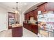 Spacious kitchen with an island, stainless steel appliances, and dark wood cabinets at 25628 Hawks Run Ln, Sorrento, FL 32776