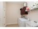 Laundry room with washer, dryer, and ample storage at 25628 Hawks Run Ln, Sorrento, FL 32776
