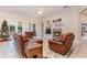 Comfortable living room with leather seating, a fireplace, and a view of the Christmas tree at 25628 Hawks Run Ln, Sorrento, FL 32776