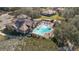 Community pool with surrounding patio and building at 25628 Hawks Run Ln, Sorrento, FL 32776