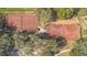 Two well-maintained tennis courts nestled in a wooded area at 25628 Hawks Run Ln, Sorrento, FL 32776