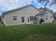 House's back features a patio, grassy yard, and a grill at 501 Heritage Trail St, Kissimmee, FL 34759