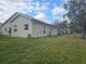 Large backyard with green grass and partial home view at 501 Heritage Trail St, Kissimmee, FL 34759
