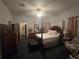 Spacious bedroom with a post bed, ample closet space, and an ensuite bathroom at 501 Heritage Trail St, Kissimmee, FL 34759