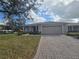 Tan house with a two-car garage and well-manicured lawn at 501 Heritage Trail St, Kissimmee, FL 34759