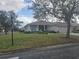 Tan house with a two-car garage and front porch at 501 Heritage Trail St, Kissimmee, FL 34759