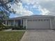 One-story house featuring a two-car garage and well-manicured lawn at 501 Heritage Trail St, Kissimmee, FL 34759