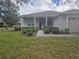 Tan one-story house with a two-car garage and landscaped front yard at 501 Heritage Trail St, Kissimmee, FL 34759