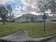 One-story house with light-colored siding, a manicured lawn, and a partially visible driveway at 501 Heritage Trail St, Kissimmee, FL 34759