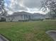 House with a large front yard, showcasing a side view of the home at 501 Heritage Trail St, Kissimmee, FL 34759
