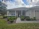 Inviting front porch with rocking chairs and nicely landscaped walkway at 501 Heritage Trail St, Kissimmee, FL 34759