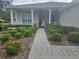 Landscaped front yard with a brick walkway leading to a covered porch at 501 Heritage Trail St, Kissimmee, FL 34759