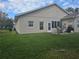 Back patio with seating and umbrella, adjacent to house at 501 Heritage Trail St, Kissimmee, FL 34759