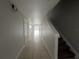 View of a hallway with tile floor and staircase at 572 Cresting Oak Cir # 19, Orlando, FL 32824