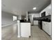 Modern kitchen with stainless steel appliances and breakfast bar at 572 Cresting Oak Cir # 19, Orlando, FL 32824
