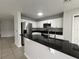 Modern kitchen with stainless steel appliances and breakfast bar at 572 Cresting Oak Cir # 19, Orlando, FL 32824