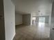 Open living room with tile floors and view of kitchen at 572 Cresting Oak Cir # 19, Orlando, FL 32824