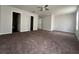 Main bedroom with carpet, ceiling fan, and two closets at 572 Cresting Oak Cir # 19, Orlando, FL 32824