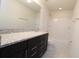 Bathroom boasts granite countertop, dark vanity and tub shower at 684 Bishop Bay Loop, Apopka, FL 32712