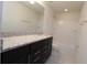 Bathroom boasts granite countertop, dark vanity and tub shower at 684 Bishop Bay Loop, Apopka, FL 32712