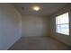 Simple bedroom with carpet, neutral walls, and window at 684 Bishop Bay Loop, Apopka, FL 32712