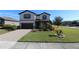 Two-story house with a landscaped yard and paved driveway at 684 Bishop Bay Loop, Apopka, FL 32712