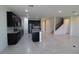 Open kitchen boasts dark cabinets, granite counters & island at 684 Bishop Bay Loop, Apopka, FL 32712