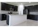 Spacious kitchen with dark cabinetry, granite counters, and island at 684 Bishop Bay Loop, Apopka, FL 32712