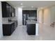 Open kitchen boasts dark cabinets, granite counters & island at 684 Bishop Bay Loop, Apopka, FL 32712