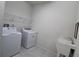 Bright laundry room with washer, dryer, and shelving at 684 Bishop Bay Loop, Apopka, FL 32712