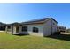 Home's back features a covered patio and solar panels at 684 Bishop Bay Loop, Apopka, FL 32712