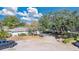 Aerial view of a single-Gathering home with a large yard and driveway at 7201 Pleasant Dr, Orlando, FL 32818