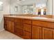 Double vanity bathroom with wood cabinets and neutral tile at 7201 Pleasant Dr, Orlando, FL 32818