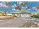 Single-story home with a large driveway and mature trees at 7201 Pleasant Dr, Orlando, FL 32818