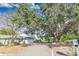 Home with a long driveway and mature landscaping at 7201 Pleasant Dr, Orlando, FL 32818