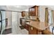 L-shaped kitchen island with granite countertops and wood cabinets at 7201 Pleasant Dr, Orlando, FL 32818