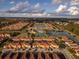 Aerial perspective of community with lake, pool, and tennis courts at 8931 Bismarck Palm Rd, Kissimmee, FL 34747