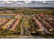 Aerial view showing home location in a community with a lake and lush landscaping at 8931 Bismarck Palm Rd, Kissimmee, FL 34747